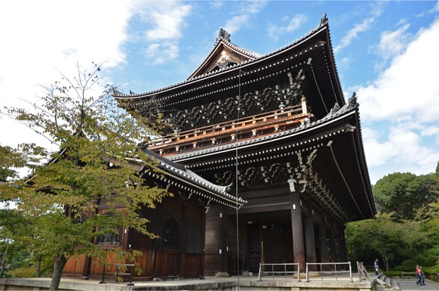 Compare the size of the gate to the people in the bottom right-hand corner