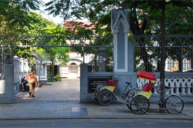A pedicab driver waits for customers
