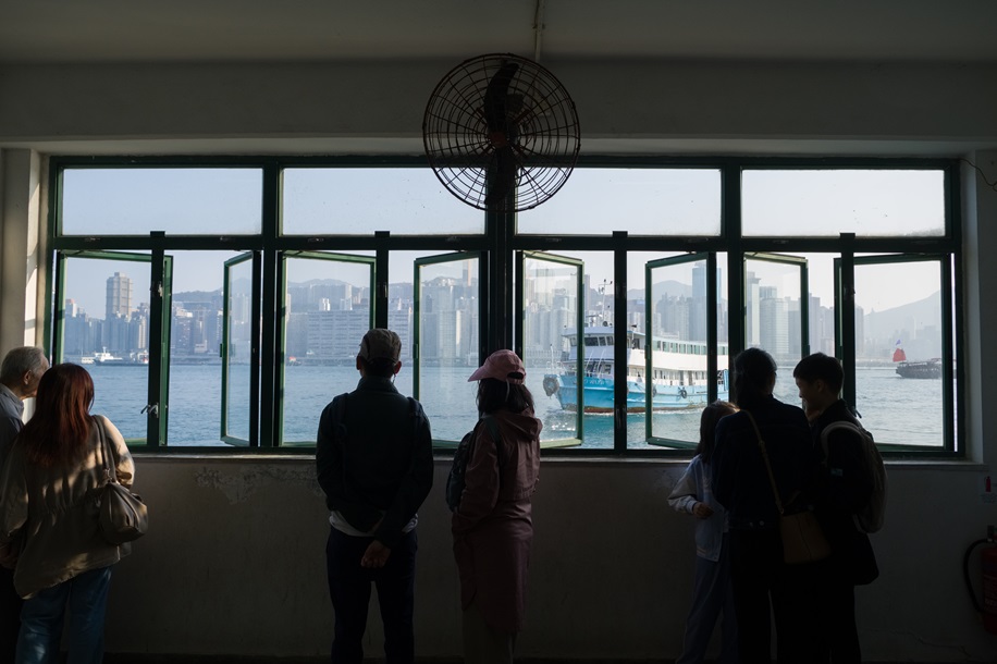 Passengers wait for the ferry to North Point