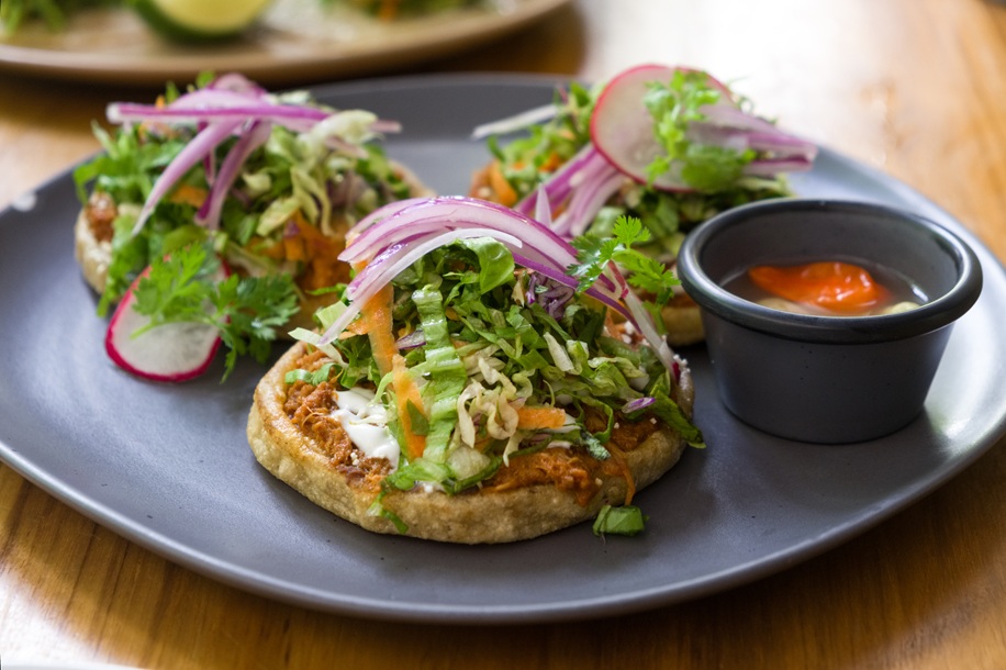 Sopes de Cochito Chiapaneco (Chiapas pot-roasted pork on a base of fried masa) in Palenque